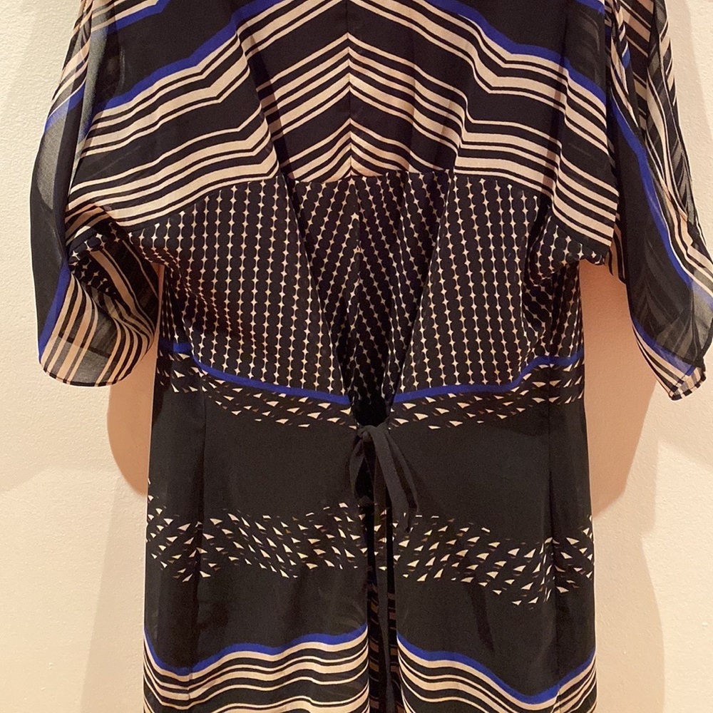 Black dress size XS with open slit on top of sleeves. Ties at the waist.